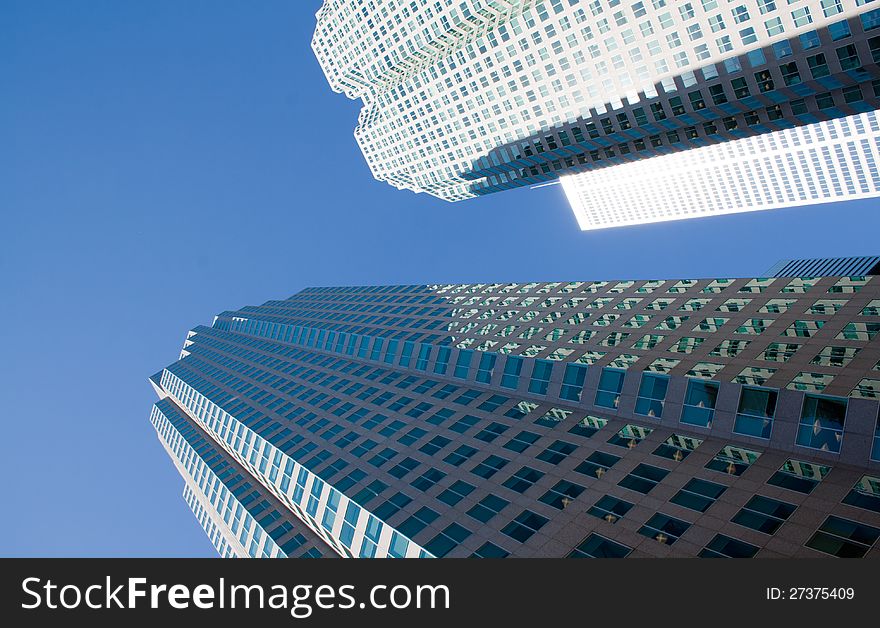 Two isolated  skyscrapers on a background of clear blue sky.