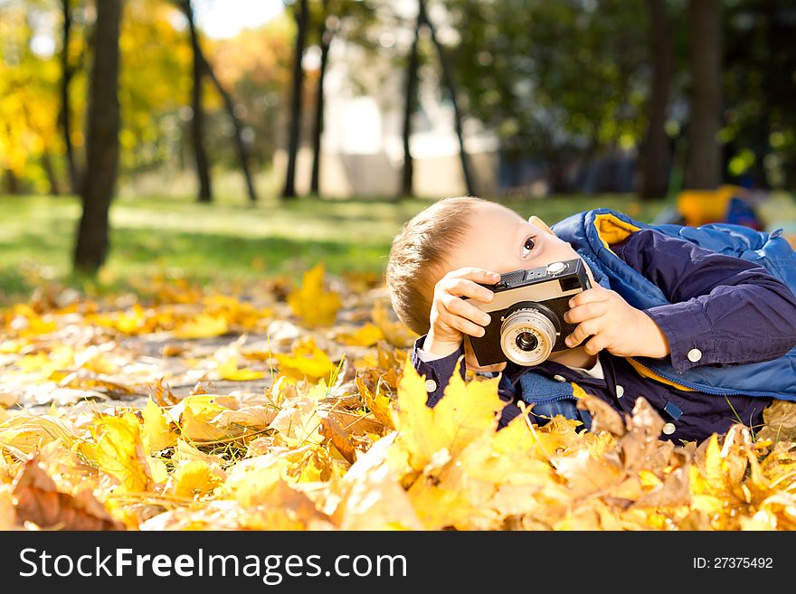 Small Boy Playing With A Slr Camera