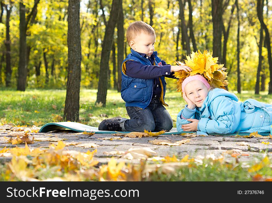 Little Boy Making An Autumn Hat For His Sister