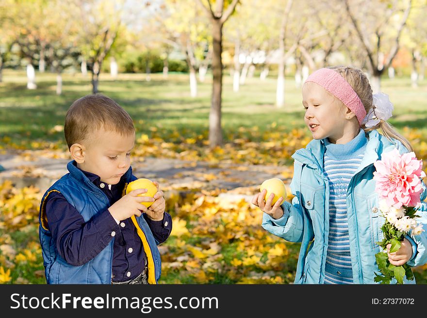 Little Boy And Girl Eating Apples