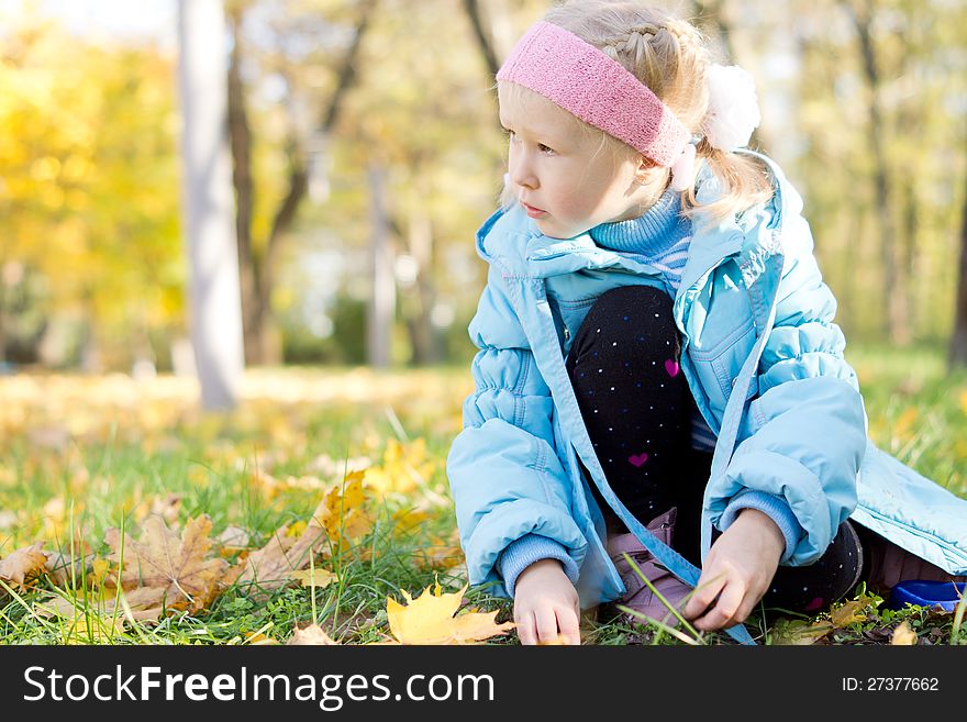 Young Girl Sitting In A Park
