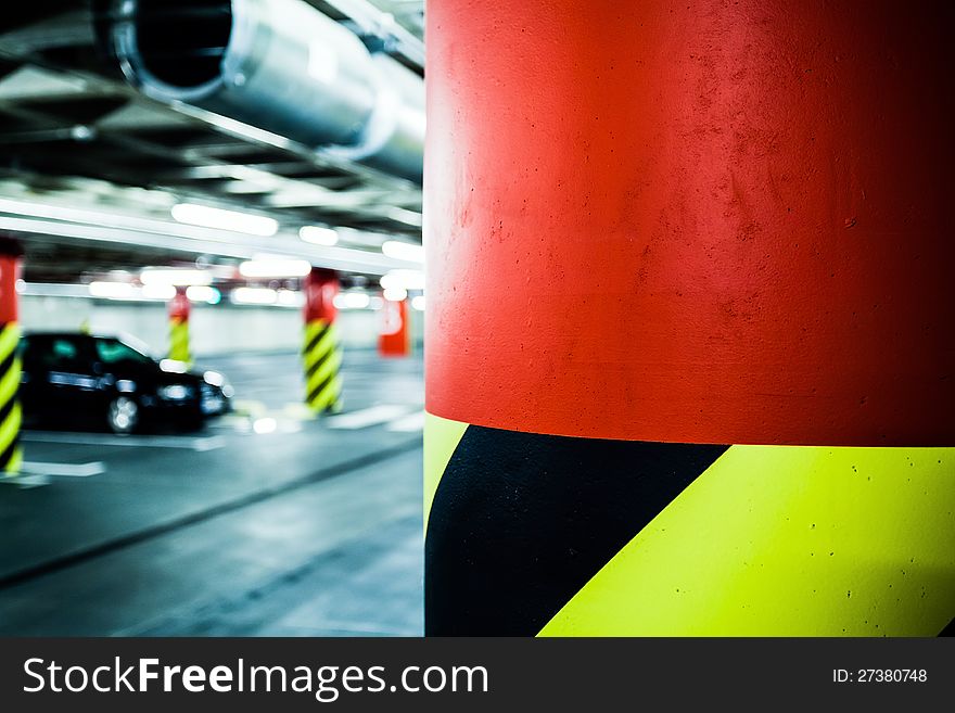 Parking garage underground interior. Bright neon light in industrial building basement, steel and concrete. Parking garage underground interior. Bright neon light in industrial building basement, steel and concrete.