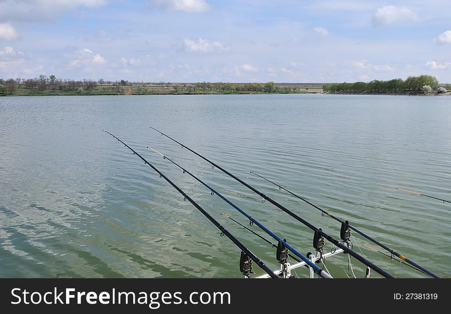 summer rest of fishing hobby on lake with fishing rods