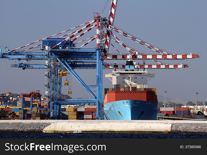 Container ship working in port with cranes. Container ship working in port with cranes