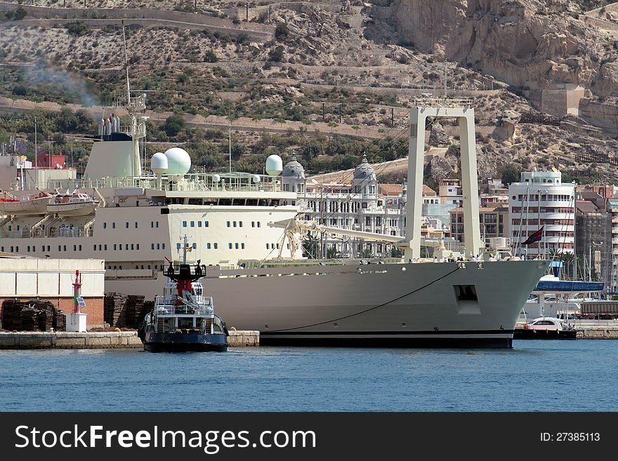 Merchant ship leaving port helped for tug. Merchant ship leaving port helped for tug