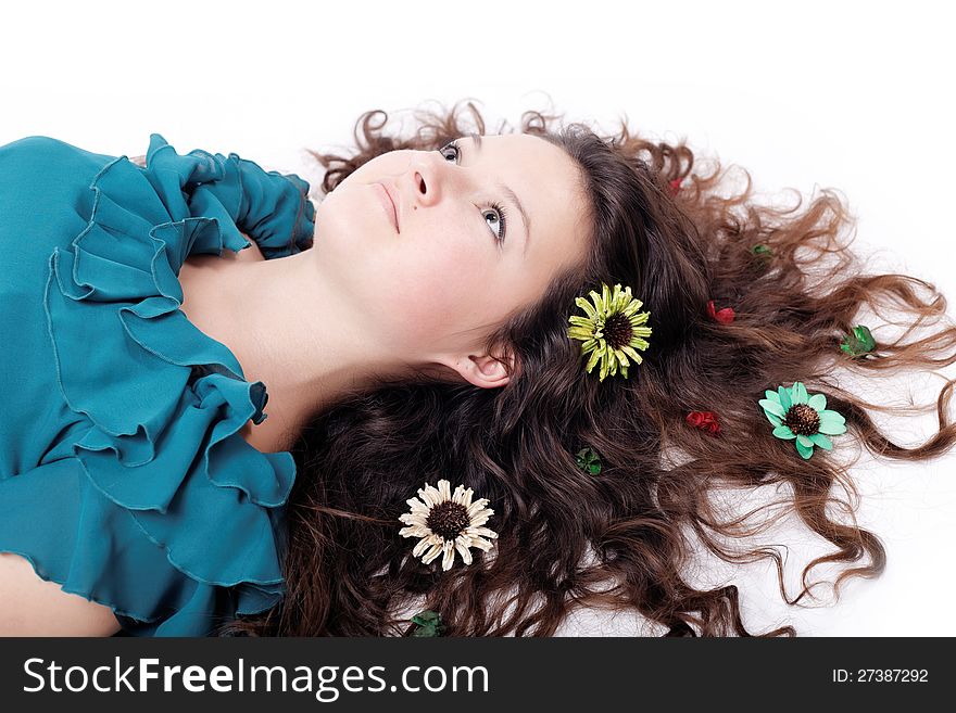 Portrait of pretty brunette girl posing with long curly hair