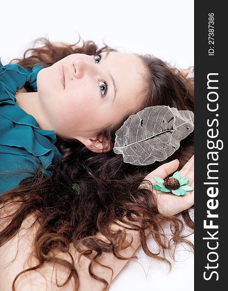 Portrait of brown-haired girl with long curly hair isolated