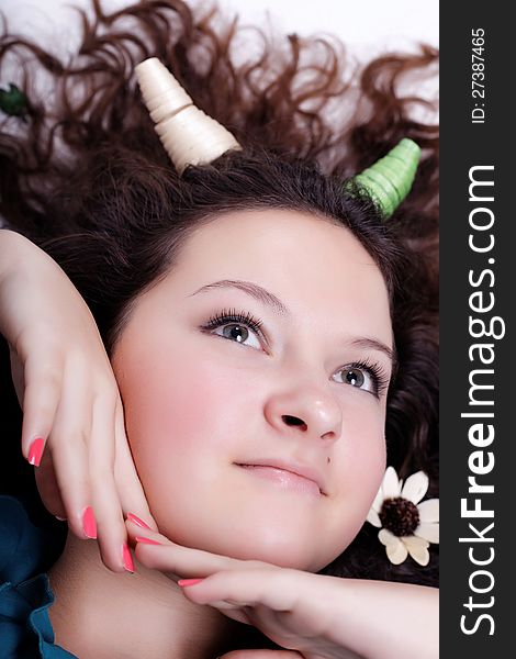 Portrait of pretty brunette with horns