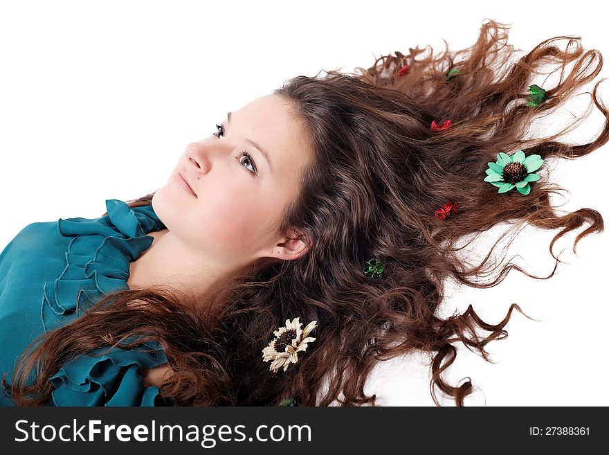 Glamorous portrait of brunette girl with flowers in her hair isolated