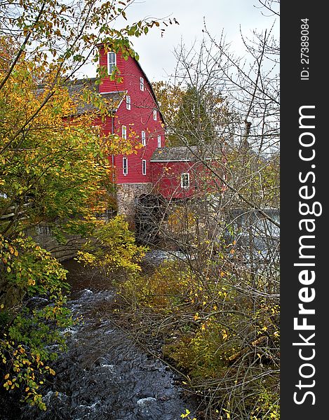 A Fall view through the trees of the historic Red Mill in Clinton Township in New Jersey. A Fall view through the trees of the historic Red Mill in Clinton Township in New Jersey.