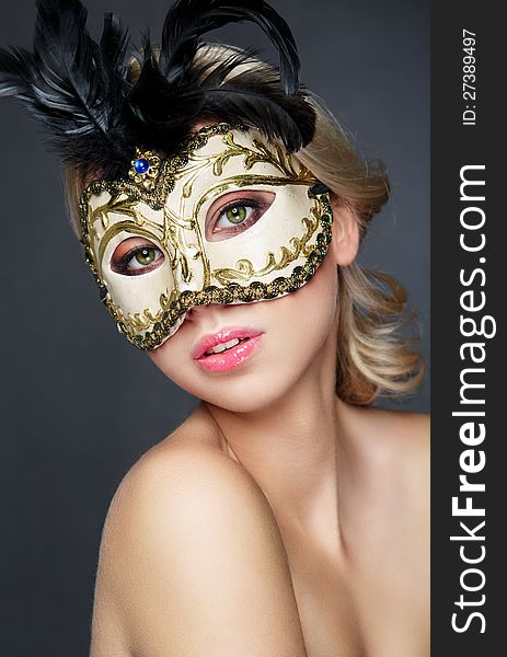 Girl in mask carnival,studio,gray background