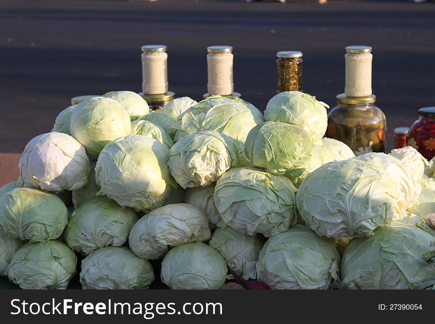 White cabbage and jars of grated horseradish. White cabbage and jars of grated horseradish.