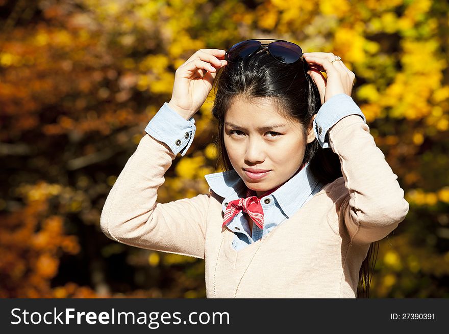 Beautiful young asian woman on a sunny day in fall. Beautiful young asian woman on a sunny day in fall
