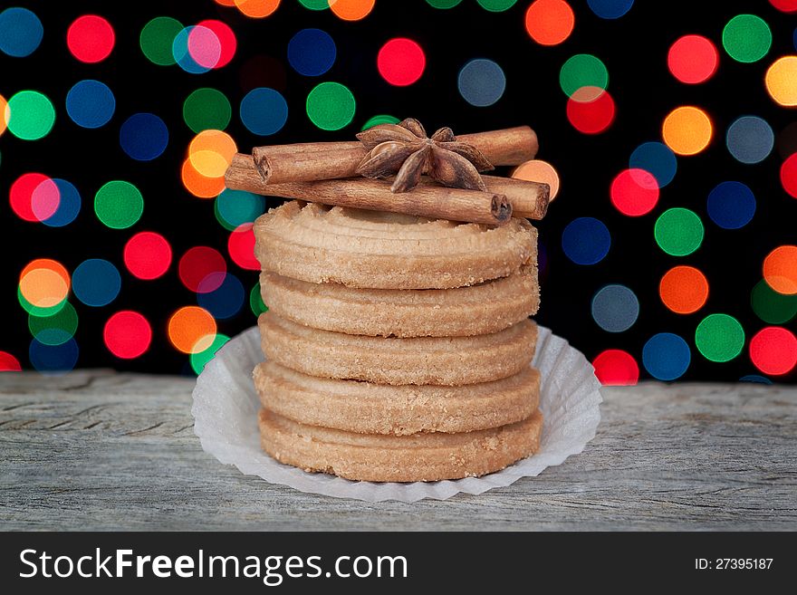 A stack of Christmas cookies, cinnamon and anise on the background of colorful bokeh. A stack of Christmas cookies, cinnamon and anise on the background of colorful bokeh.