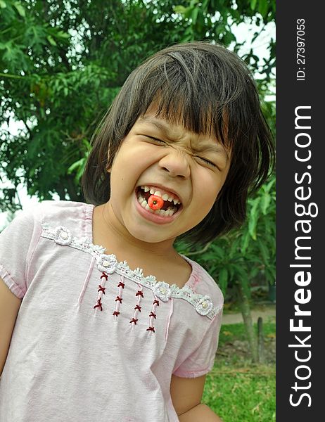 Asian Child Girl Eating Cherry From The Garden