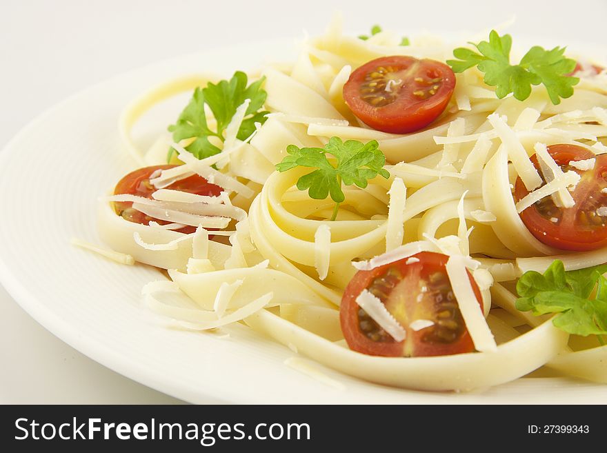 Italian pasta linguini with cheese and cherry tomatoes. Italian pasta linguini with cheese and cherry tomatoes