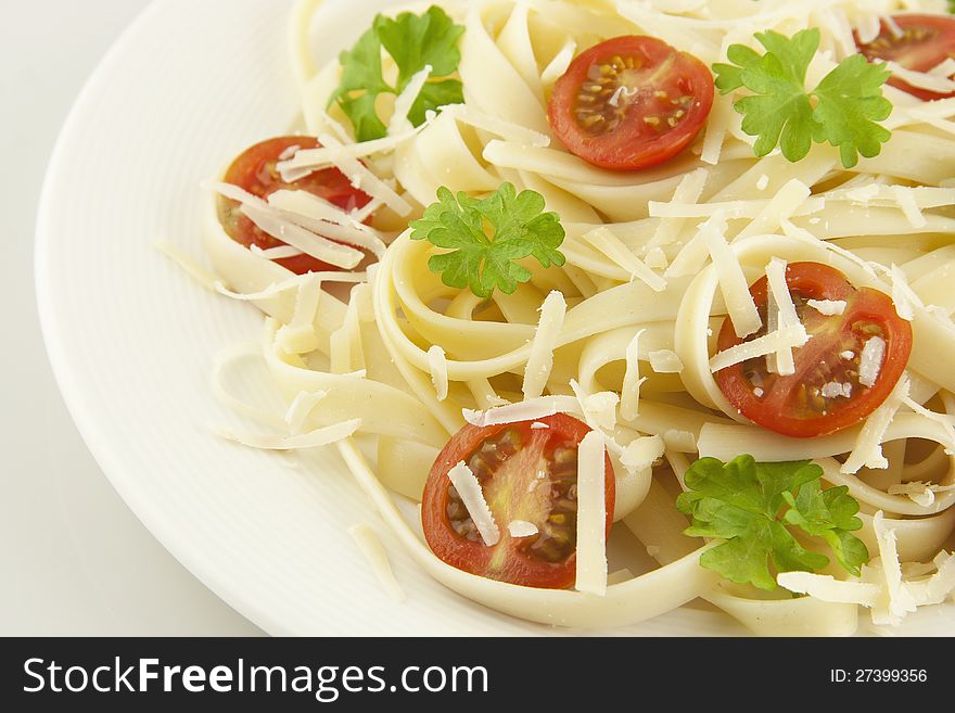 Italian pasta linguini with cheese and cherry tomatoes. Italian pasta linguini with cheese and cherry tomatoes