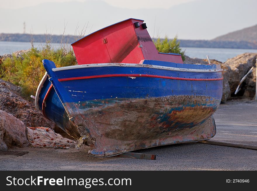 A small fishing boat out on the dock for repairs. A small fishing boat out on the dock for repairs