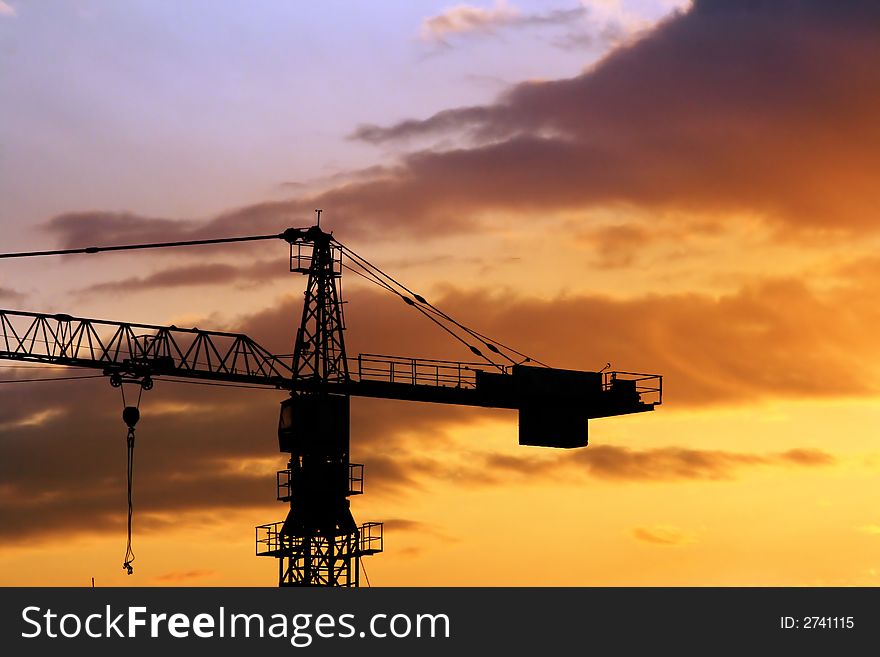 Beautiful sky and silhouette of crane at sunrise in city. Beautiful sky and silhouette of crane at sunrise in city.