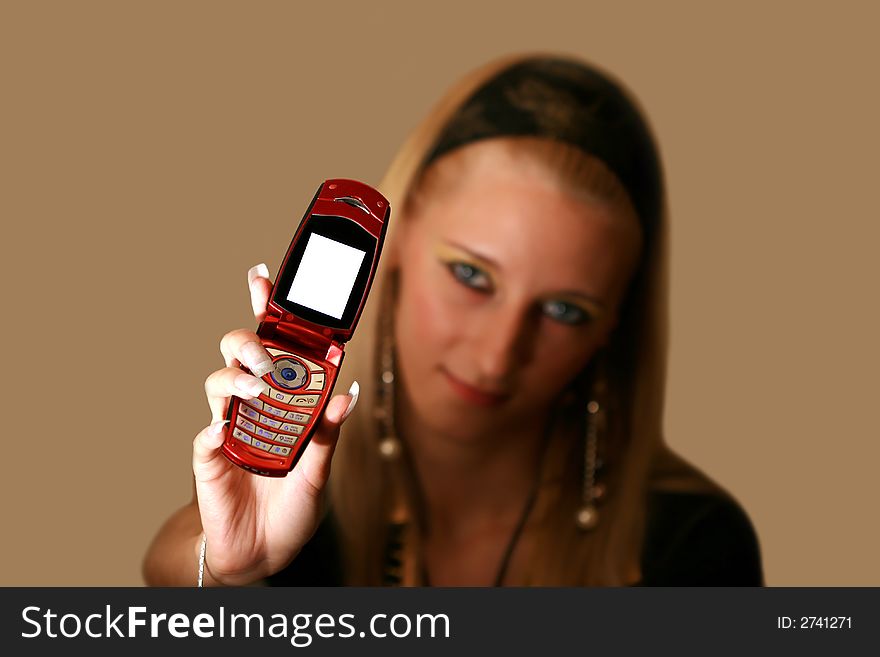 Young beautiful  blond girl with mobile phone, focus on telephone