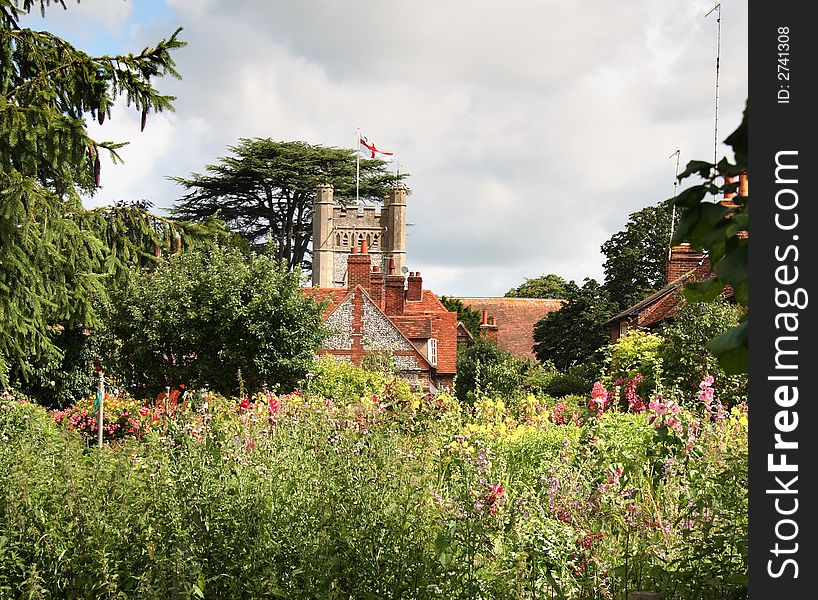 English Village Church viewed from a flower filled Cottage Garden