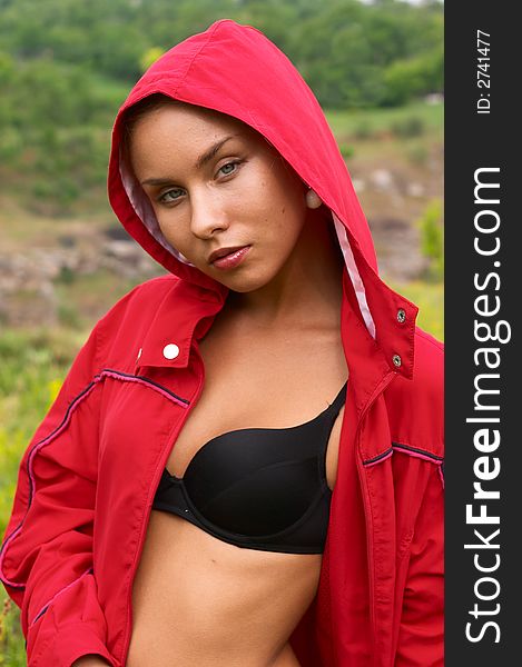 Seducing girl in red jacket and black bra