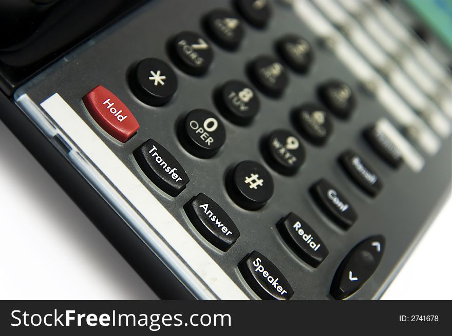 Close up of modern office phone. Selective focus on the first row of buttons. Close up of modern office phone. Selective focus on the first row of buttons