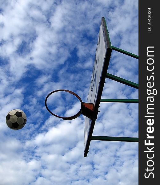 Outdoor basketball,
lovely cloudy background,
football in air,