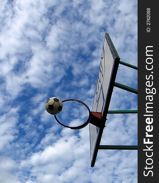 Outdoor basketball,
lovely cloudy background,
football in air,
