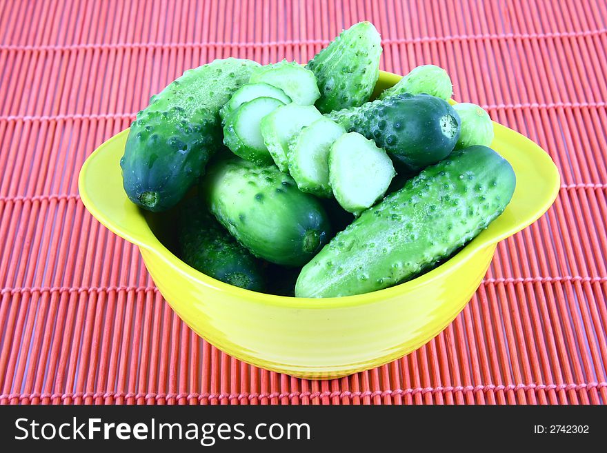 A Cucumber progressively sliced on a white background