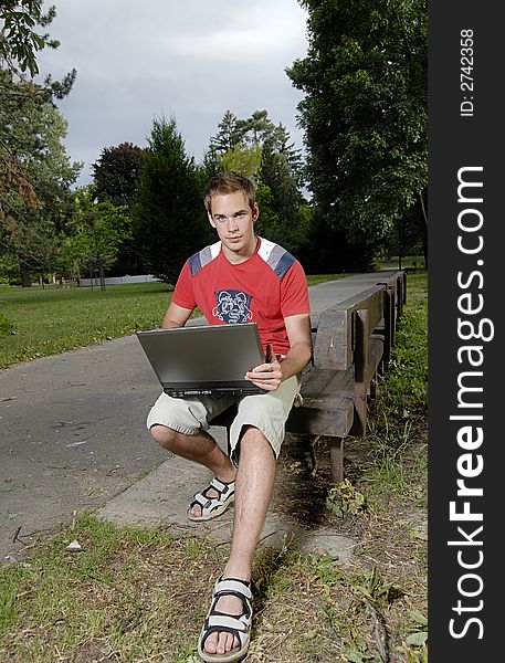 Picture of young man with notebook in park