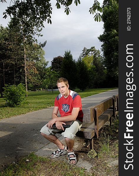 Picture of young man with notebook in park