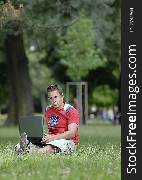 Picture of young man with notebook in park