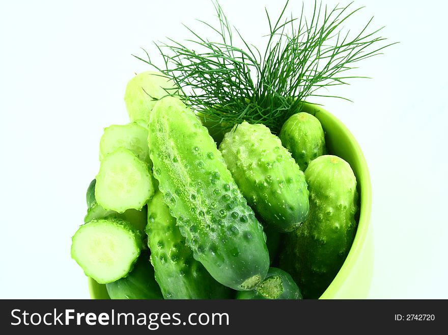 A Cucumber progressively sliced on a white background