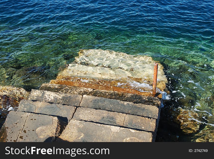 Old concrete stairs entering into the sea. Old concrete stairs entering into the sea