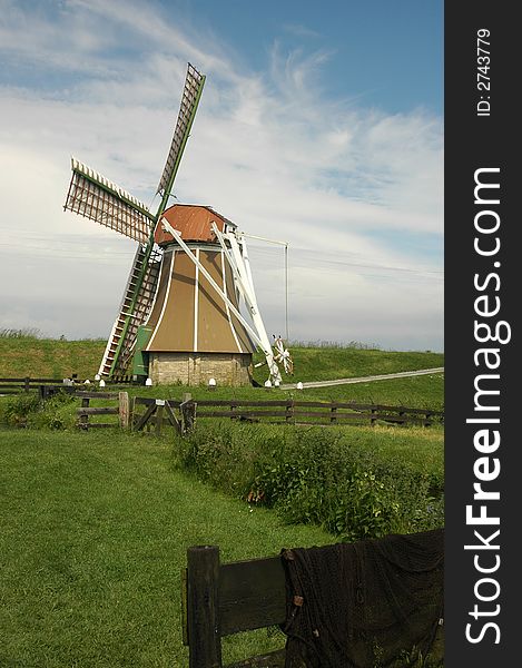 A small windmill near the the IJselmeer in the Netherlands. A small windmill near the the IJselmeer in the Netherlands.