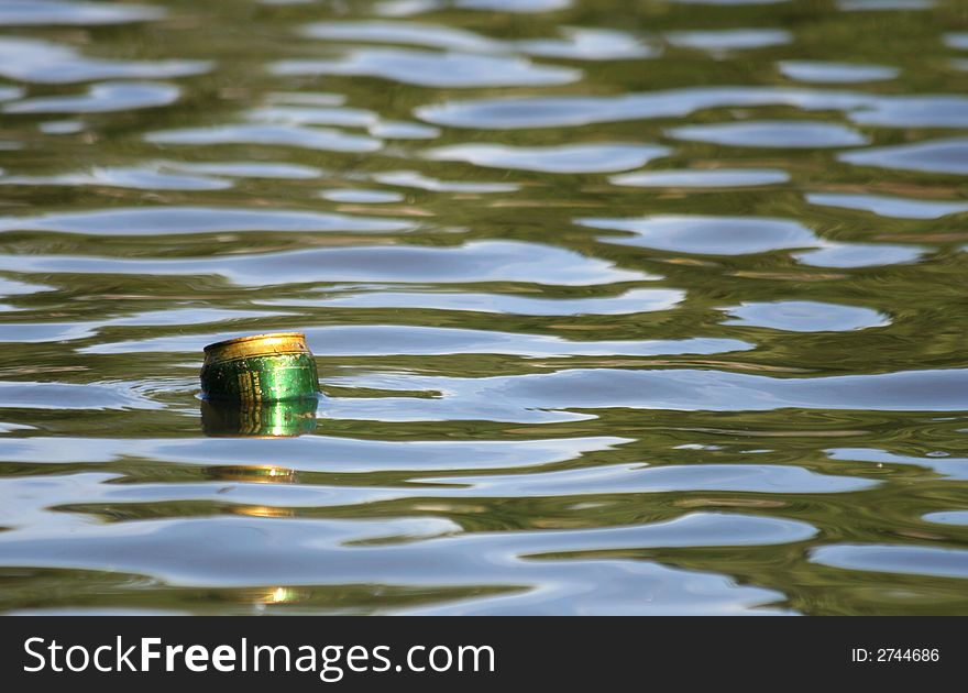 Aluminum can floating in lake. Aluminum can floating in lake