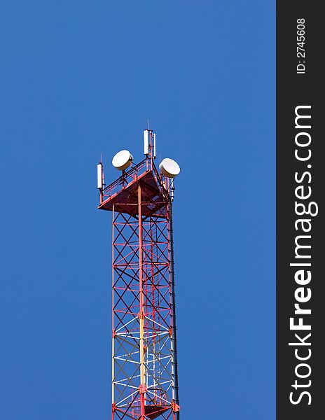 Tower of cellular communication on a background of the blue sky. Tower of cellular communication on a background of the blue sky