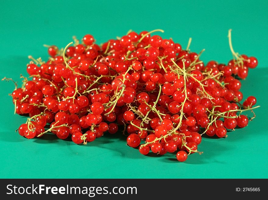 Berries of a red currant on a green background. Berries of a red currant on a green background.