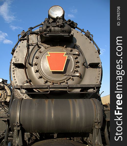Photo of steam engine in a train yard. Photo of steam engine in a train yard.