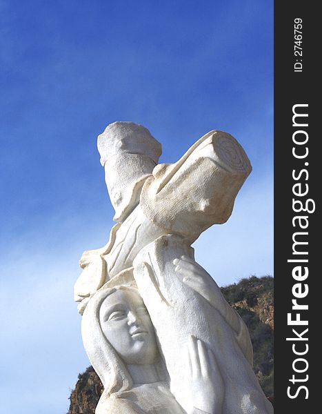Marble statue of an angel with cross