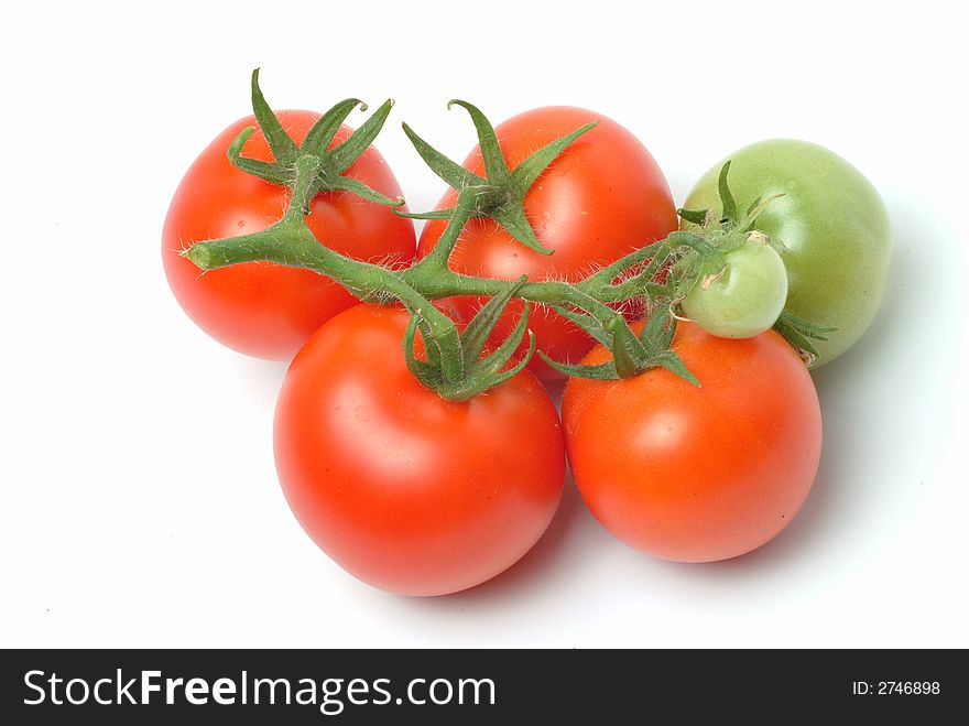 A bunch of red tomatoes on a white surface