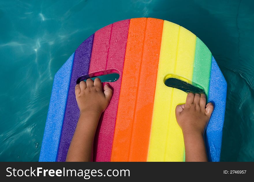 Child's hands on rainbow air-bed. Child's hands on rainbow air-bed