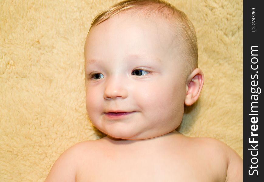 A very cute little infant laying on a fleece. A very cute little infant laying on a fleece