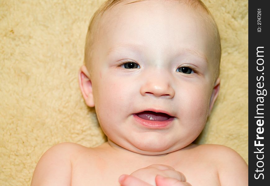 A very cute little infant on a fleece blanket. A very cute little infant on a fleece blanket