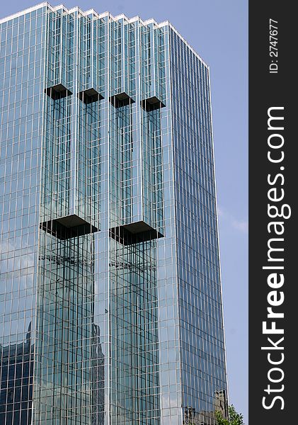 A modern glass office building against the sky. A modern glass office building against the sky