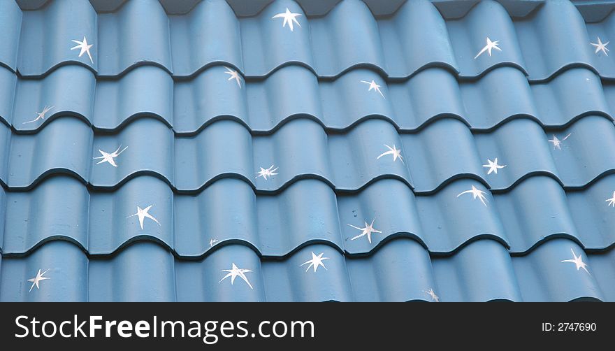 A blue tile roof painted with white stars. A blue tile roof painted with white stars