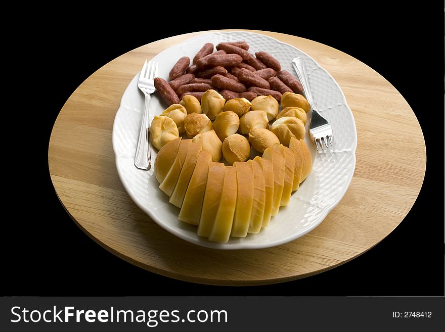 A plate of cheese and sausages - close up