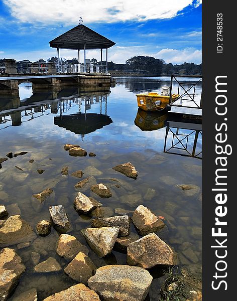 An image of reflections, calm water and blue sky. An image of reflections, calm water and blue sky.