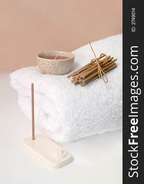 Tranquility at the spa with towel and scented candle and incense sticks. Tranquility at the spa with towel and scented candle and incense sticks